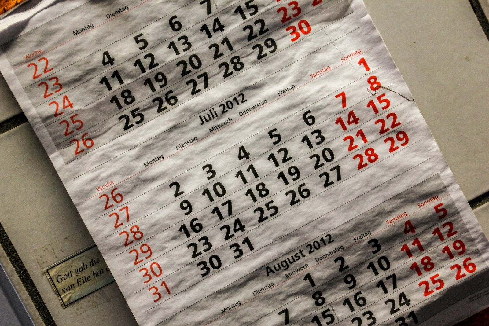 Permit fee schedule document and calculator on a desk