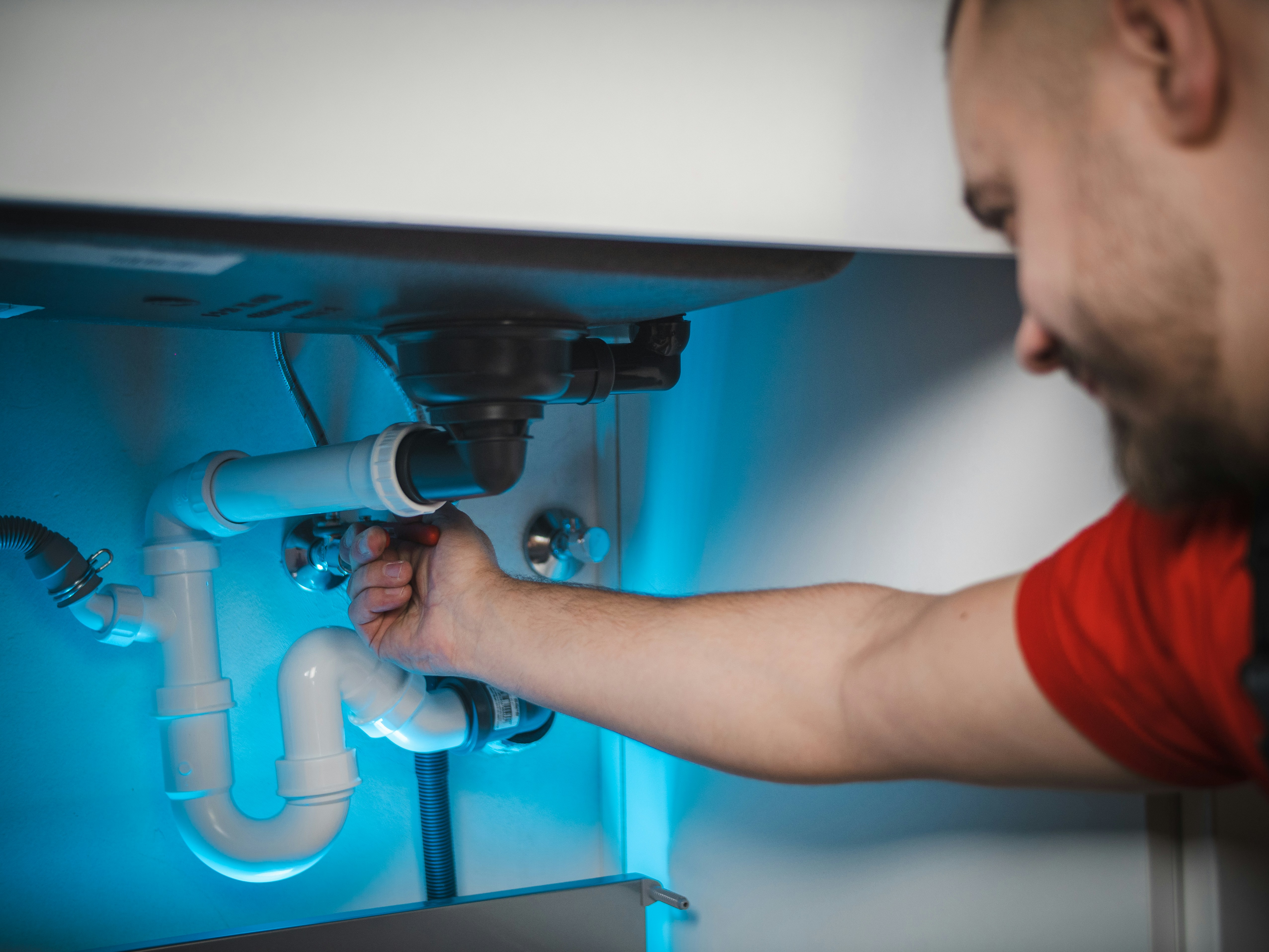 Plumber working on pipes in a San Francisco home